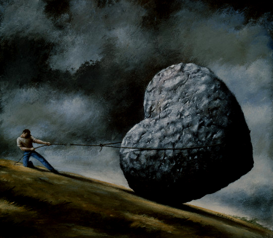 Rope Breaking on Man Holding Stone Heart on Hillside